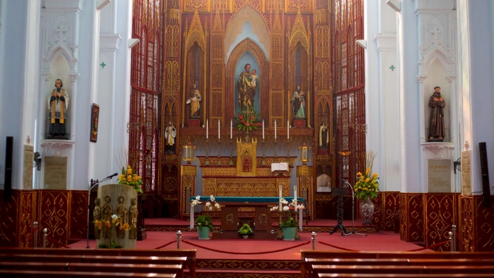 The large altar is elaborately decorated and the statues of saints are intricately carved